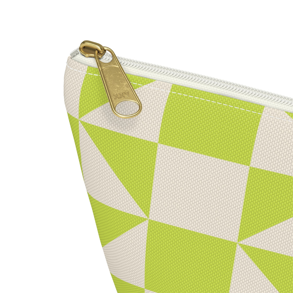 Close-up of the gold zipper pull on the lime green cream geometric makeup bag