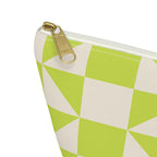 Close-up of the gold zipper pull on the lime green cream geometric makeup bag