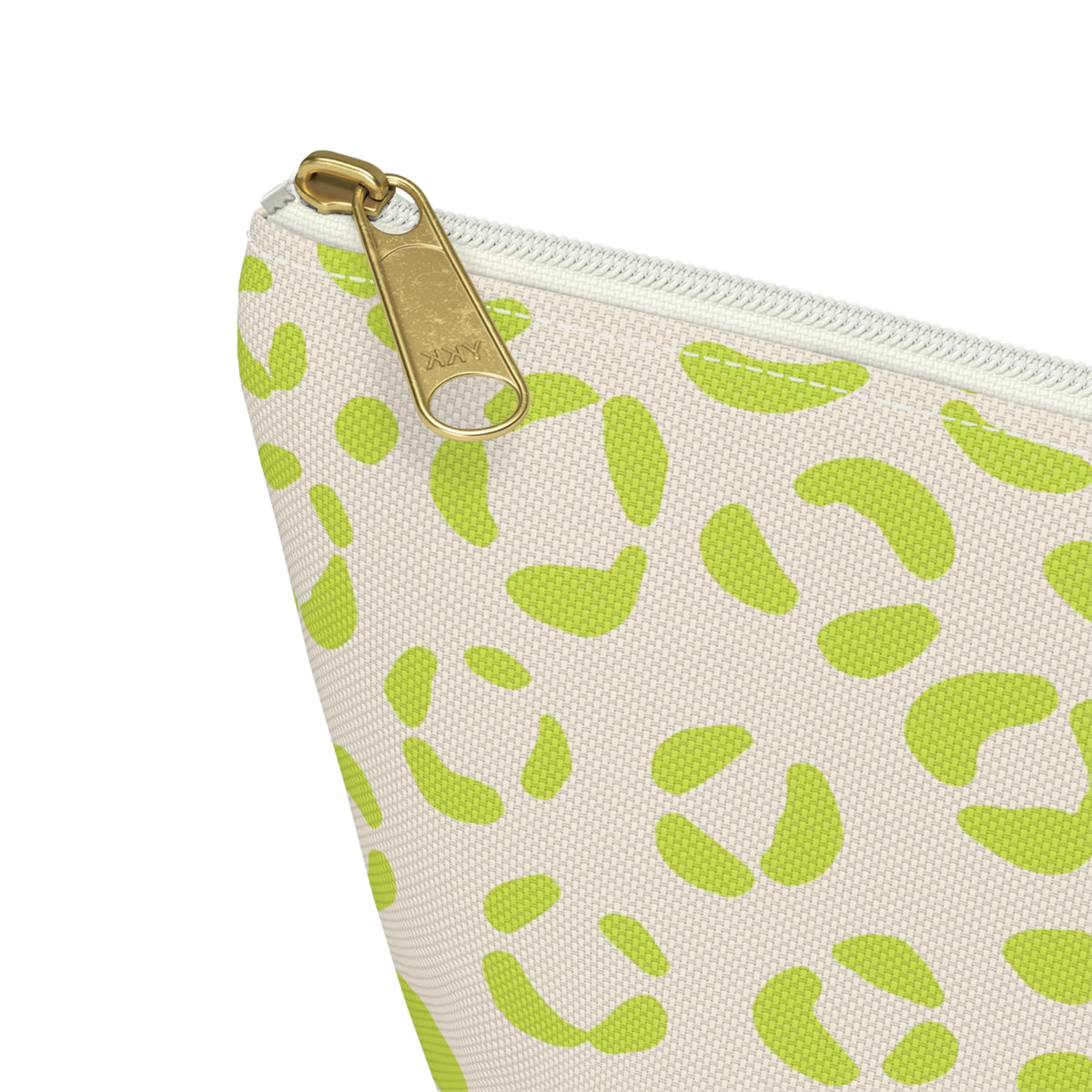 Close-up of the gold zipper pull and lime green leopard spots on the makeup bag