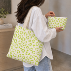 Woman with a leopard print tote bag and matching lime green makeup bag in hand