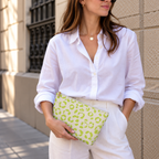 Woman in white shirt holding the lime green leopard print makeup bag as a clutch