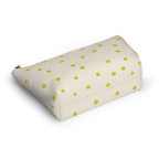 Lime green dotted cosmetic bag lying on its side