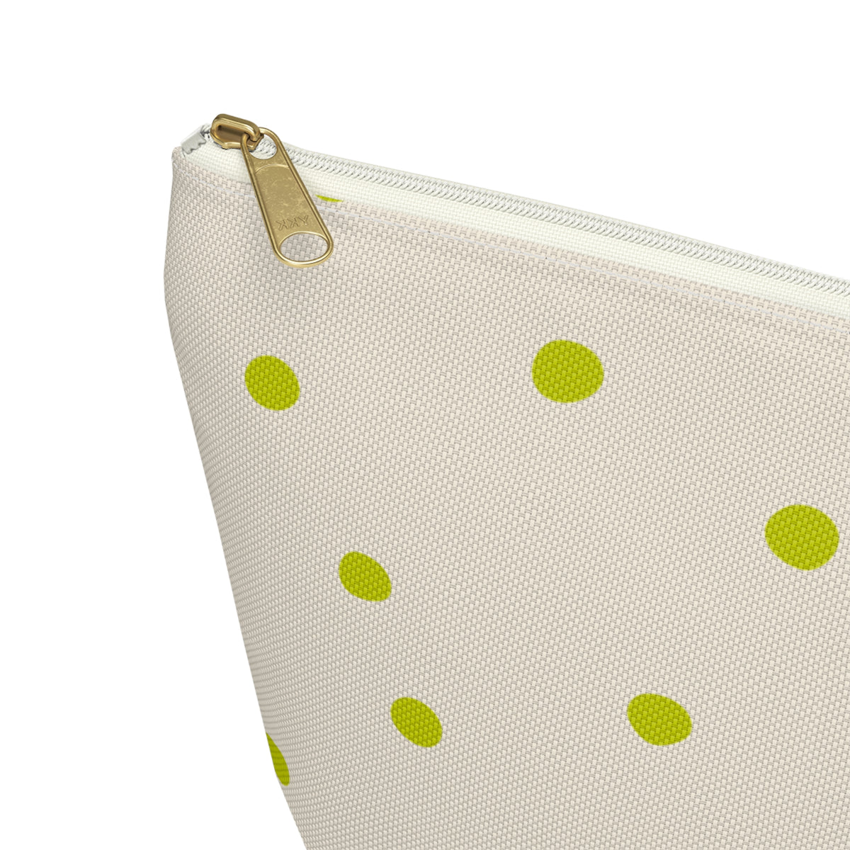Close-up of the gold zipper pull and green dots on the makeup bag
