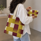 Woman carrying the matching geometric tote bag with the makeup bag in her hand