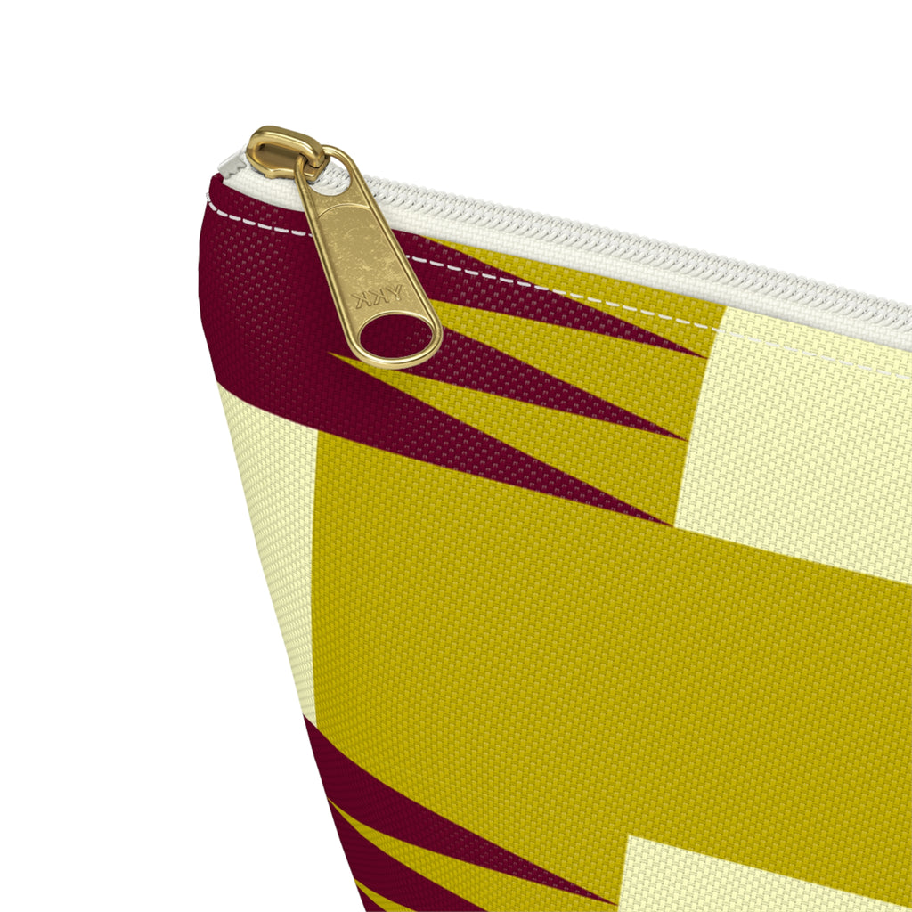 Close-up of the gold zipper pull and jagged burgundy geometric print on the makeup bag