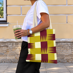 Side view of a model carrying the mustard burgundy geometric tote bag