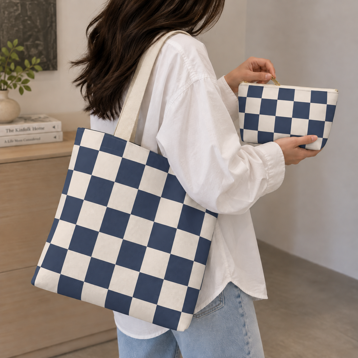 Woman carrying the navy checkered tote bag and holding the matching makeup bag