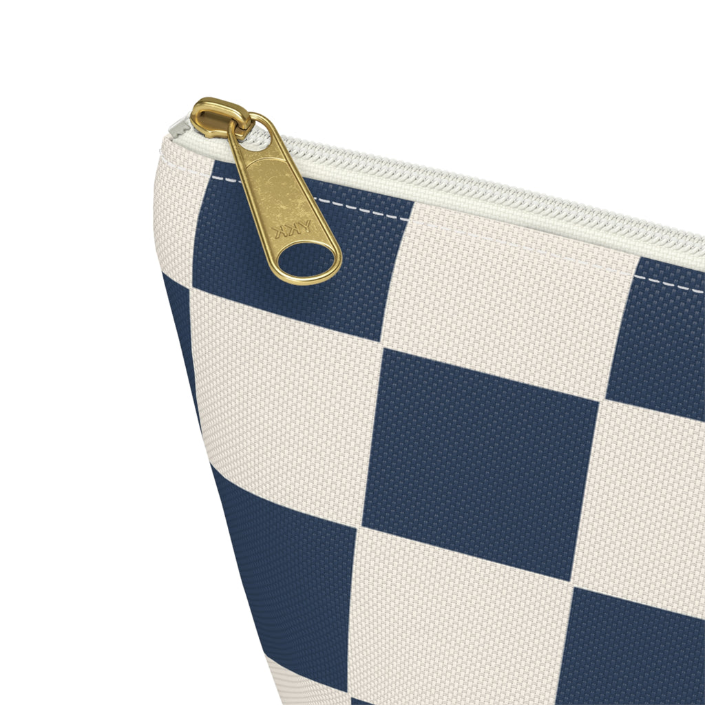 Close-up of the gold zipper pull and checkerboard print on the makeup bag