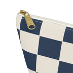Close-up of the gold zipper pull and checkerboard print on the makeup bag