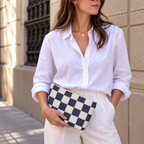 Woman in white shirt holding the navy cream checkered makeup bag