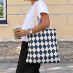 Woman walking with a navy cream diamond checkered tote bag over her shoulder