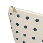 Close-up of the gold zipper pull on the navy cream polka dot makeup bag