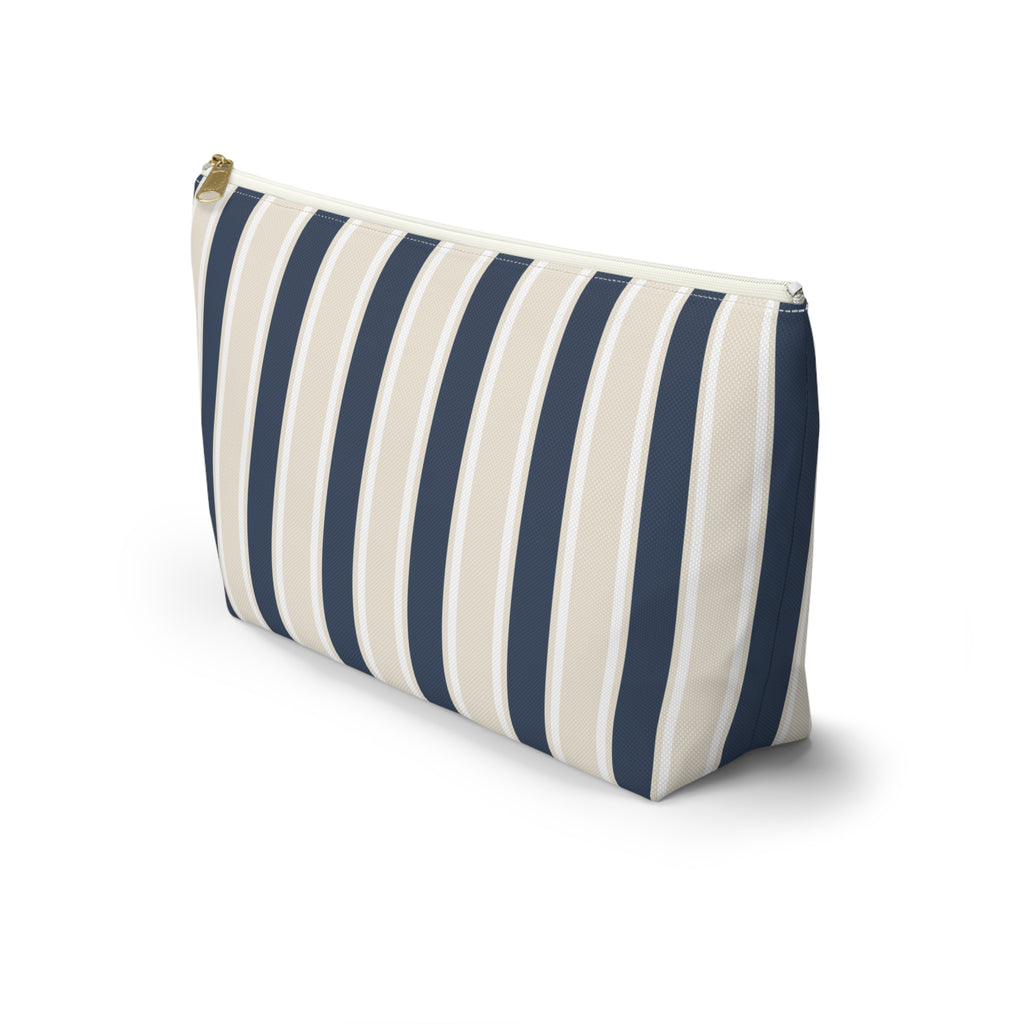 Side view of the navy cream striped makeup bag standing on a white background