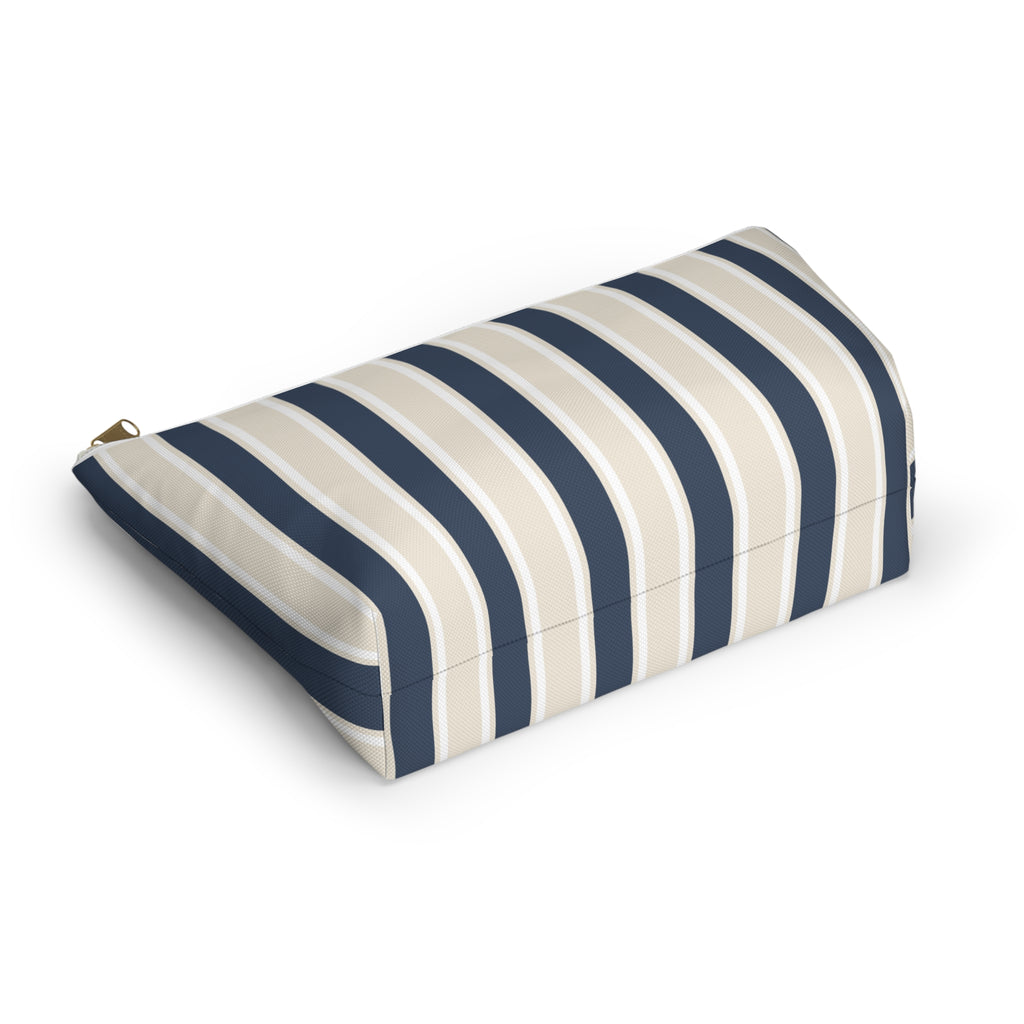 Navy cream striped makeup bag lying on its side showing the stripe pattern