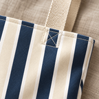 Close-up of the navy and cream stripes and the beige handle on the navy cream striped tote bag