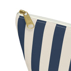 Close-up of the gold zipper pull and navy stripes on the makeup bag