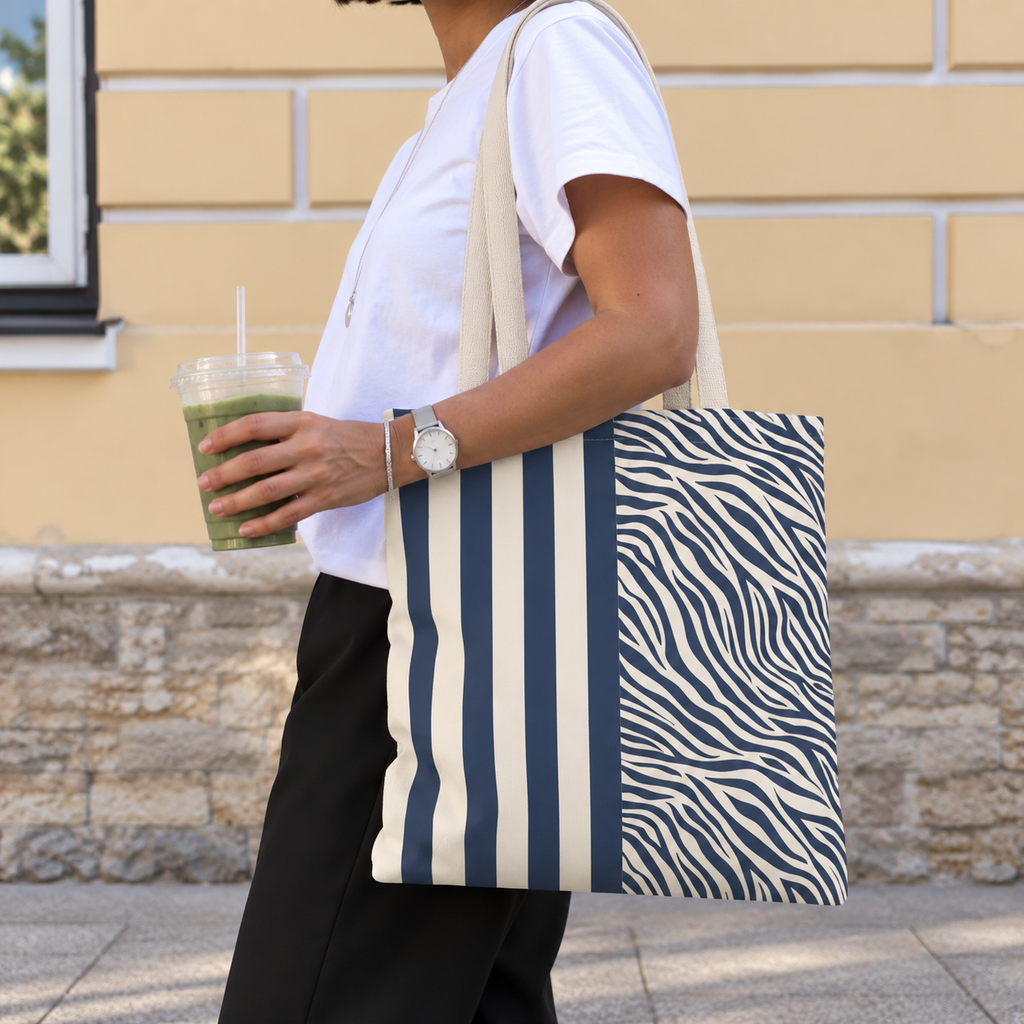 Woman with a navy cream striped tote bag with zebra print panel over her shoulder