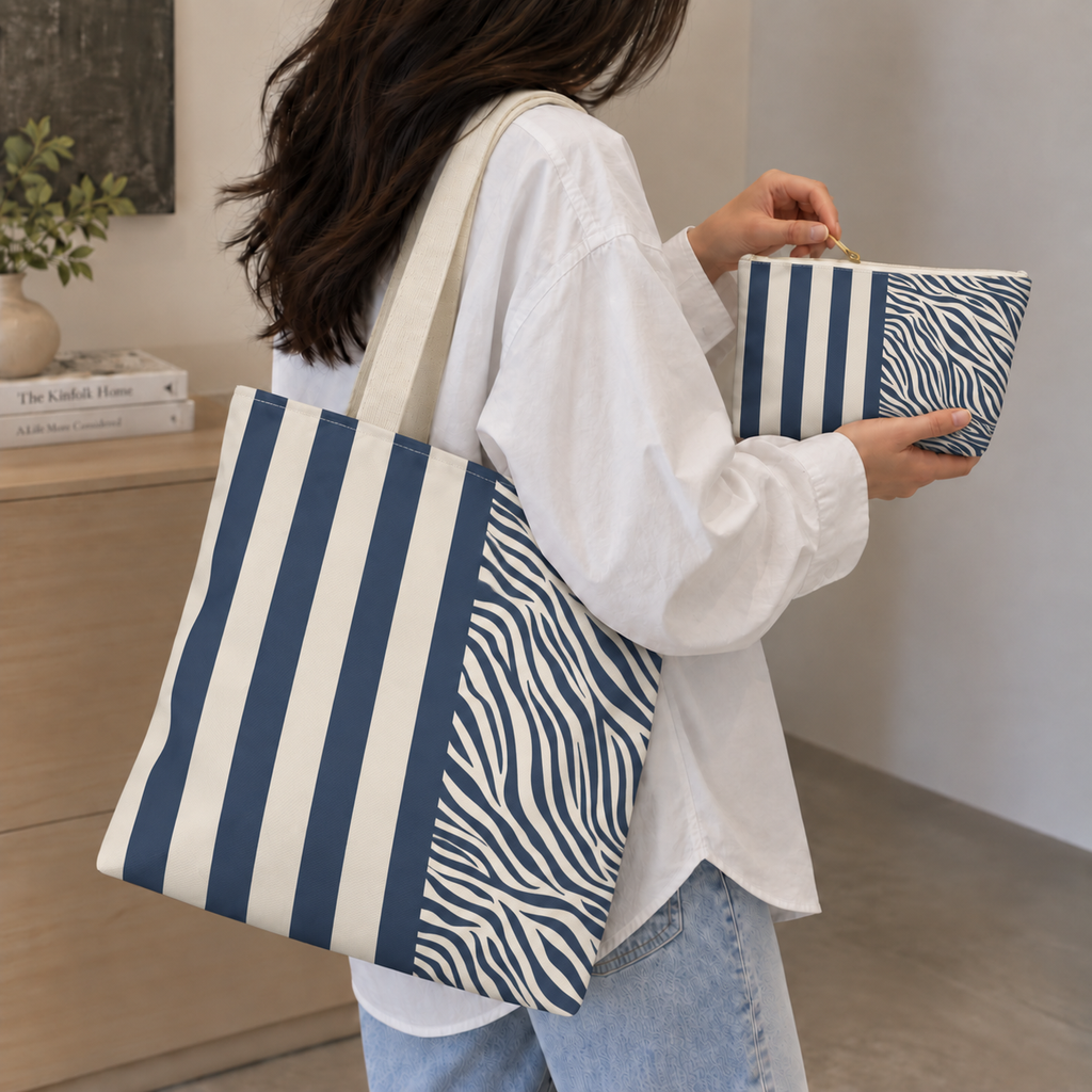 Navy cream zebra striped tote bag on the shoulder with the matching makeup bag