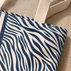 Close-up of the navy and cream zebra print panel and the tote bag handle