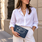 Woman in a white shirt holding the Navy White Monogram personalized makeup bag