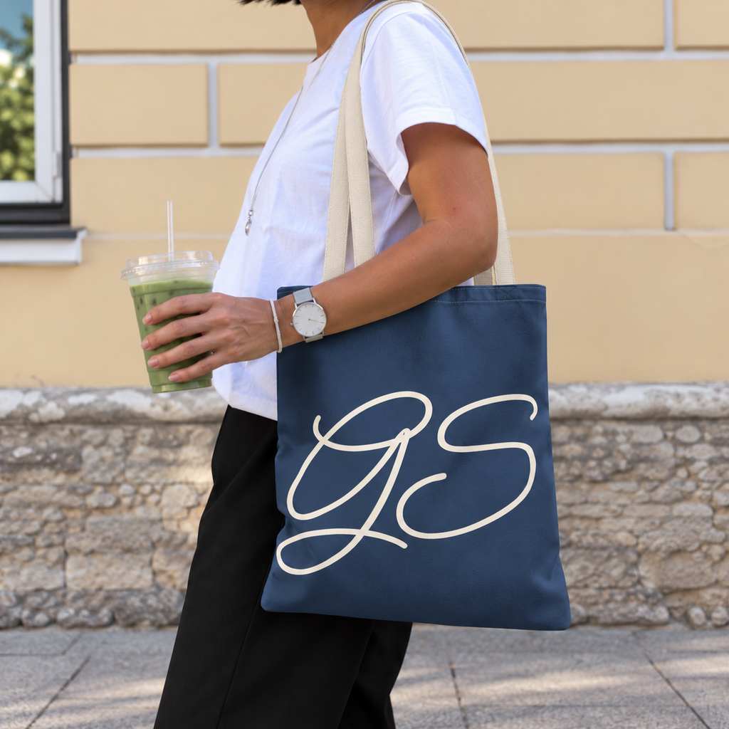 Woman carrying the Navy White Monogram personalized tote bag, side view with an iced drink