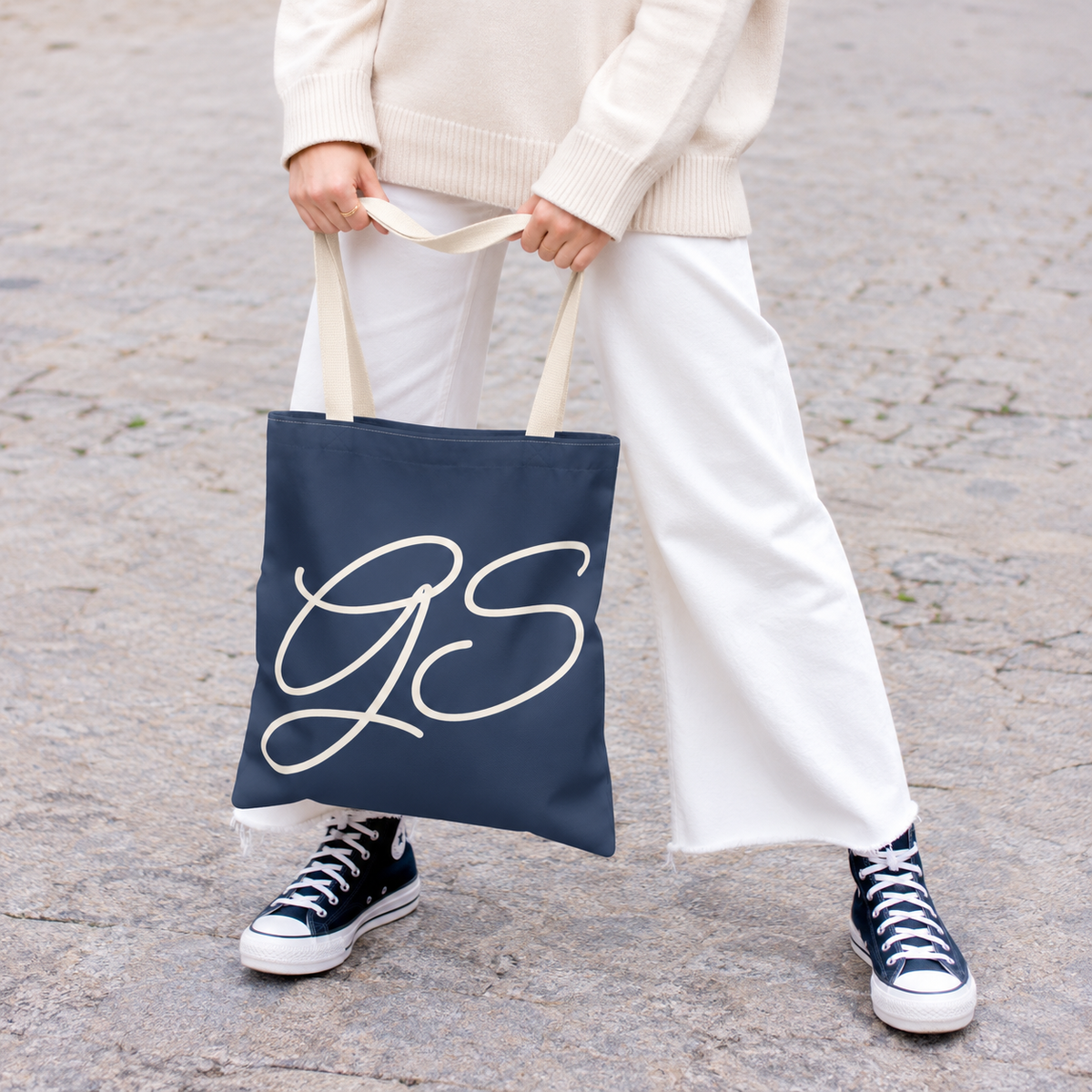 Model holding the Navy White Monogram personalized tote bag in front of white trousers