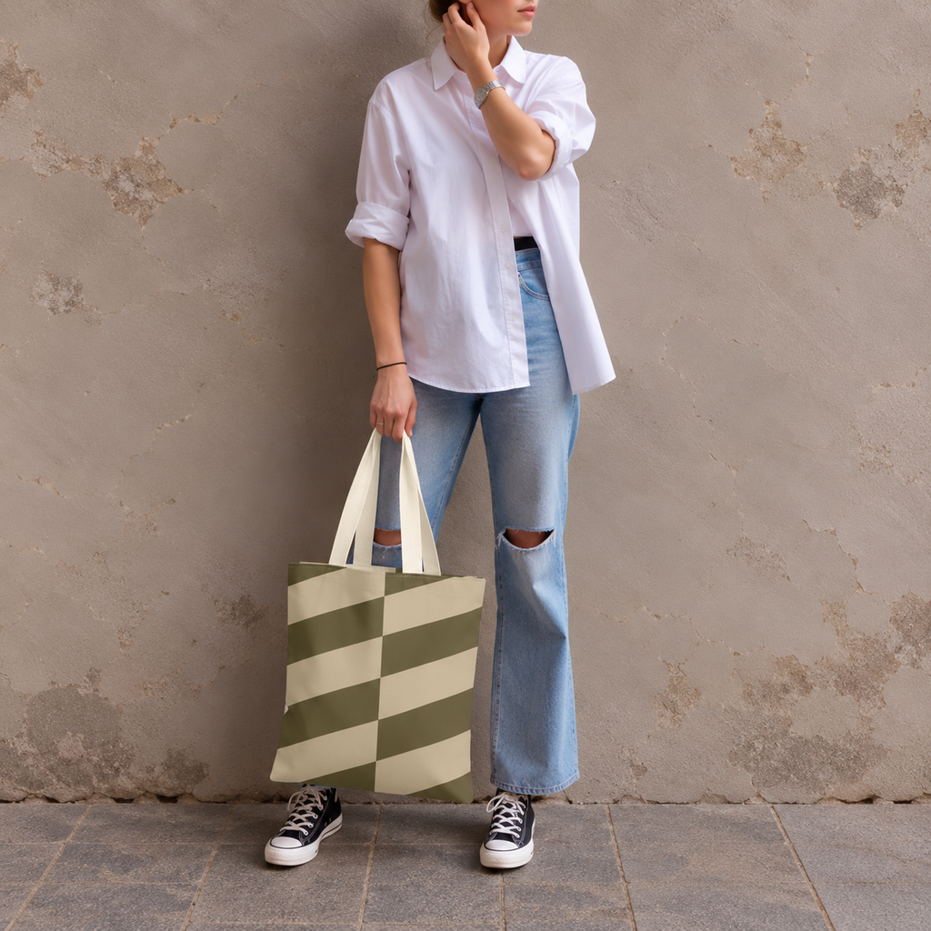 Model in jeans and a white shirt standing with the olive beige geometric tote bag