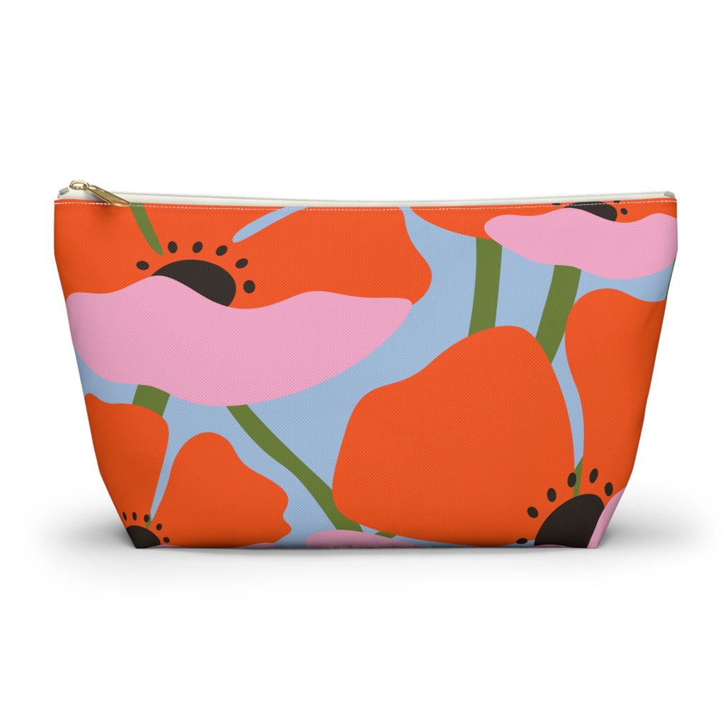 Orange poppy floral makeup bag with gold zipper pull on a white background