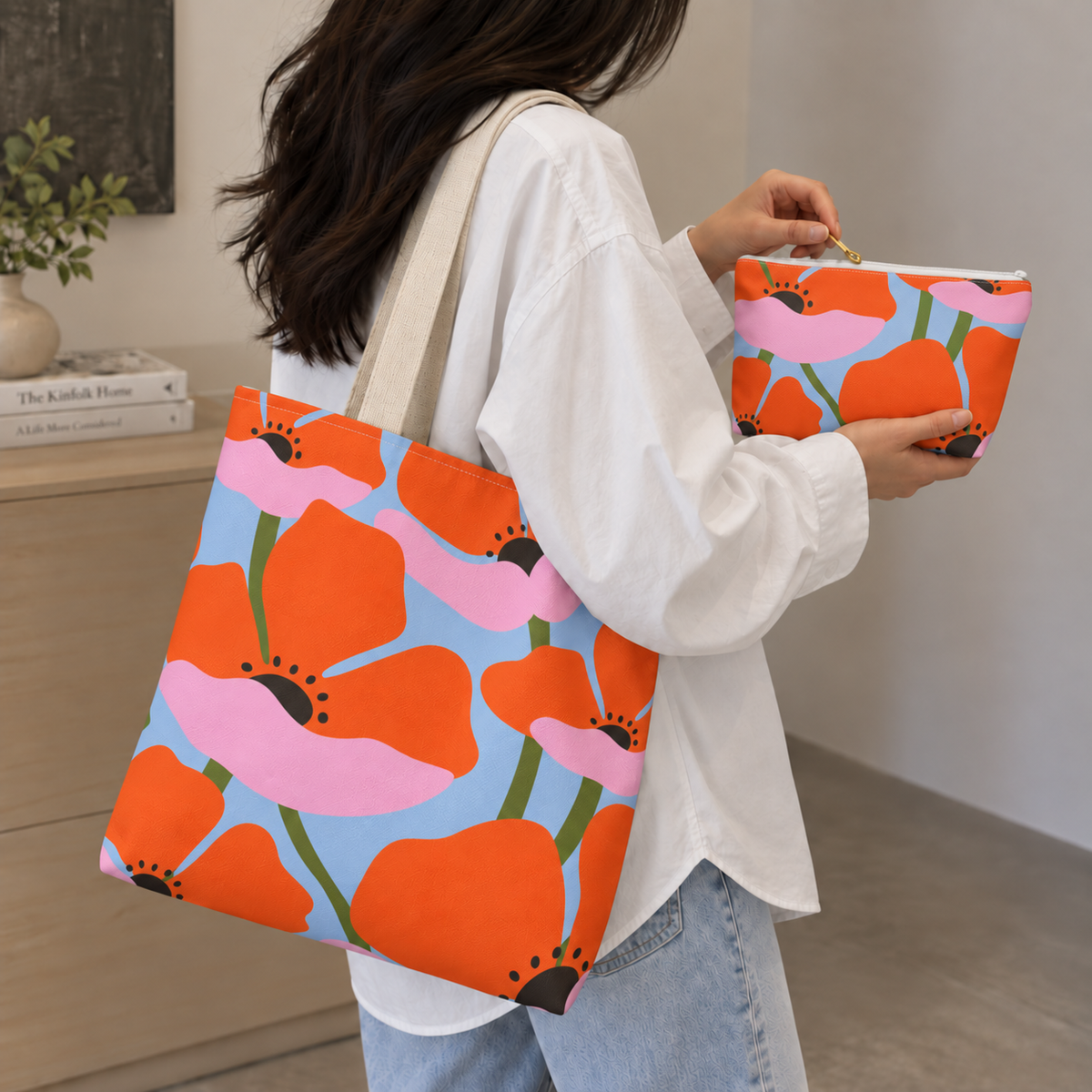 Woman carrying the orange poppy tote bag with the matching makeup bag