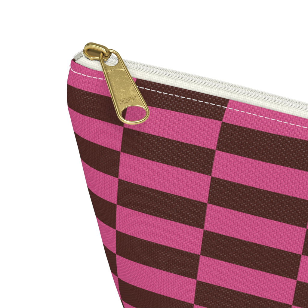 Close-up of the gold zipper pull on the pink brown checkered makeup bag