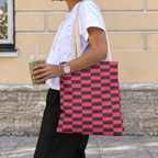 Woman carrying the pink brown checkered tote bag on her shoulder while holding a drink