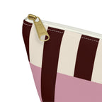 Close-up of the gold zipper pull on the pink burgundy cream striped makeup bag