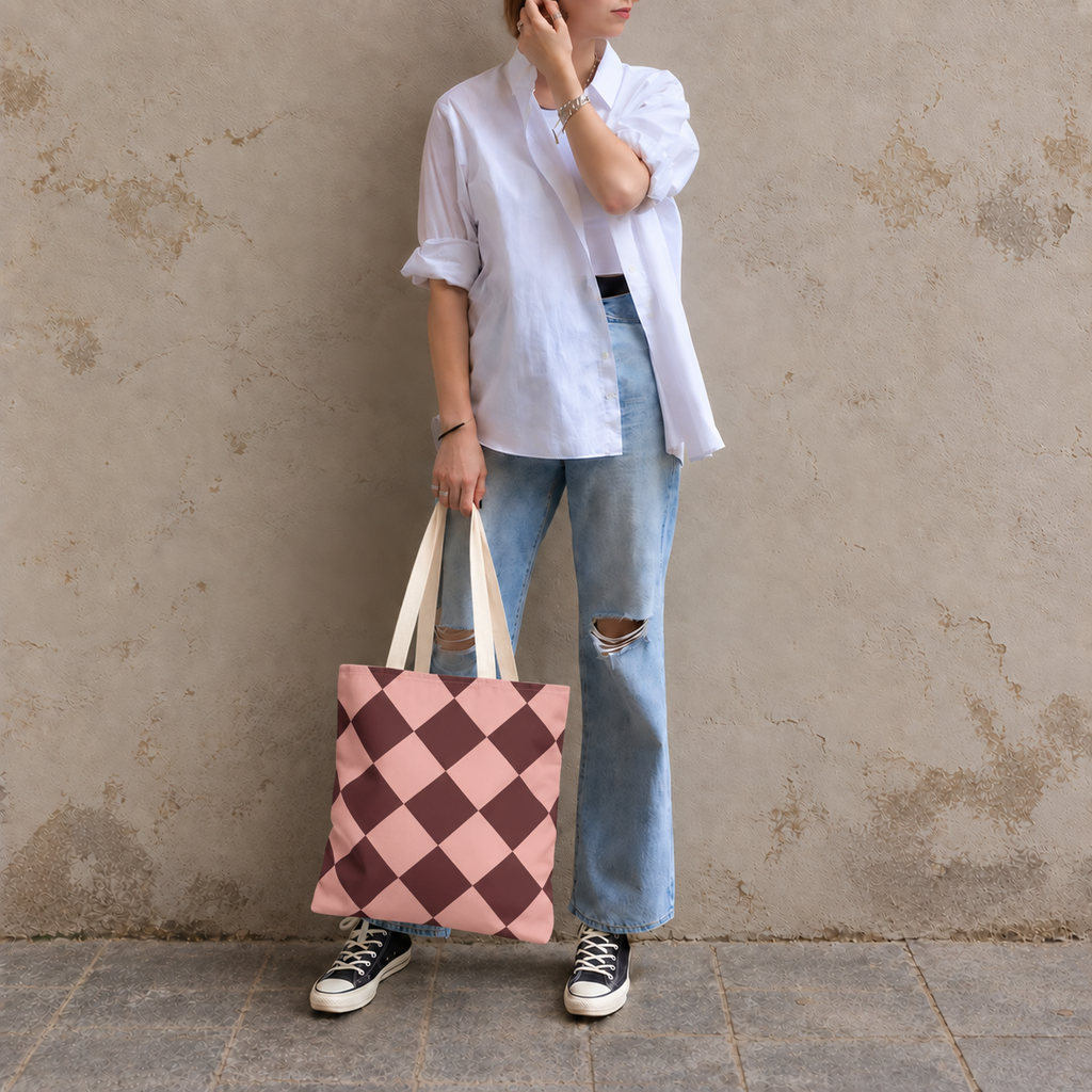 Woman in white shirt and jeans carrying the pink burgundy checkered tote bag