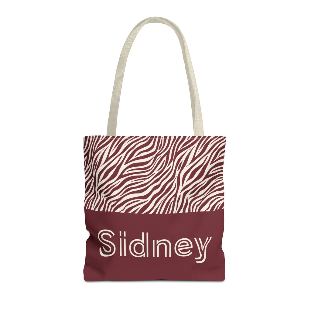 Pink burgundy zebra print personalized tote bag with a name on the burgundy panel, front view