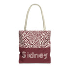 Pink burgundy zebra print personalized tote bag with a name on the burgundy panel, front view