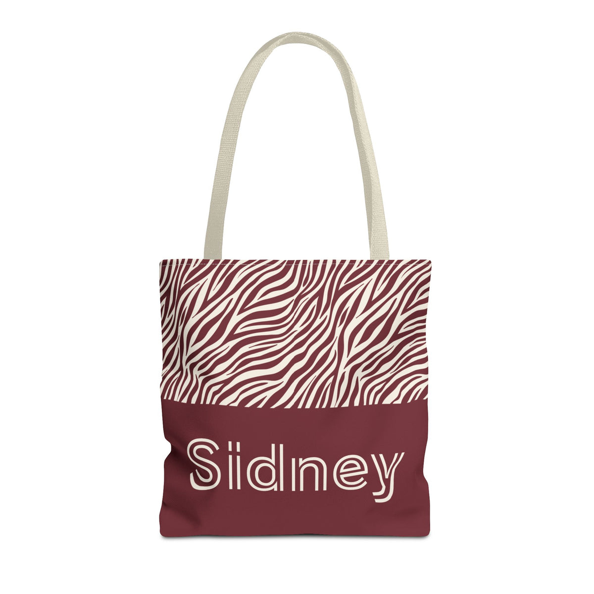 Pink burgundy zebra print personalized tote bag with a name on the burgundy panel, front view