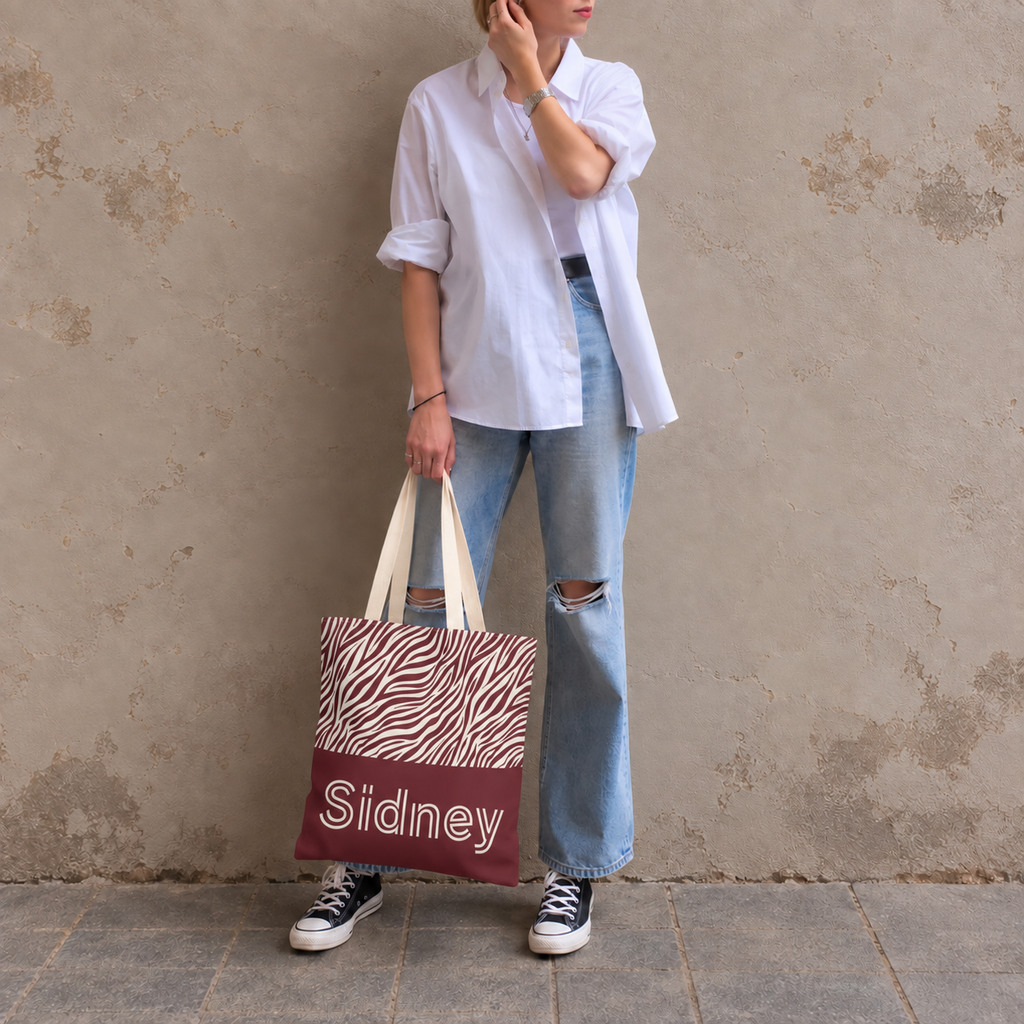 Woman in white shirt and jeans carrying the personalized zebra print tote bag