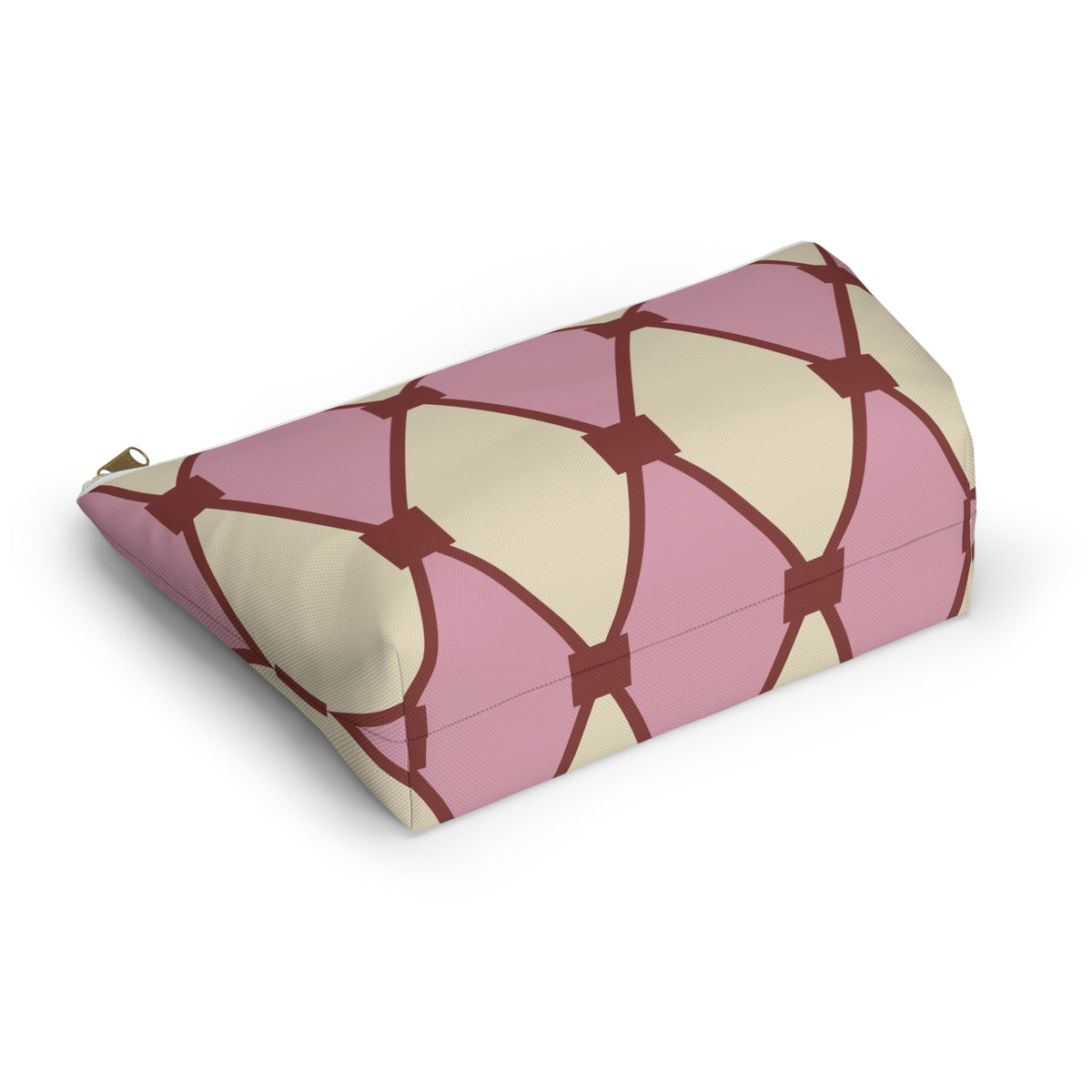 Side view of the pink cream diamond pattern makeup bag lying down