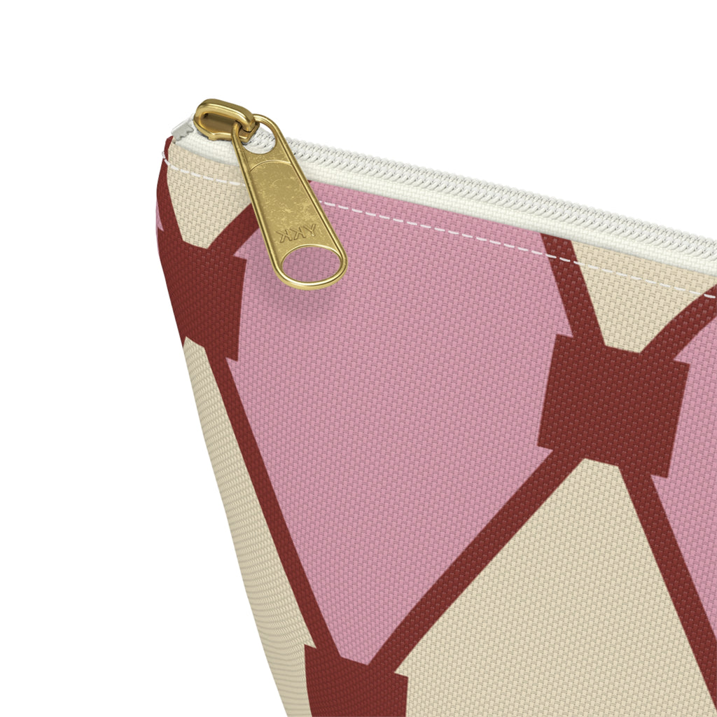 Close-up of the gold zipper pull and pink cream diamond pattern on the makeup bag