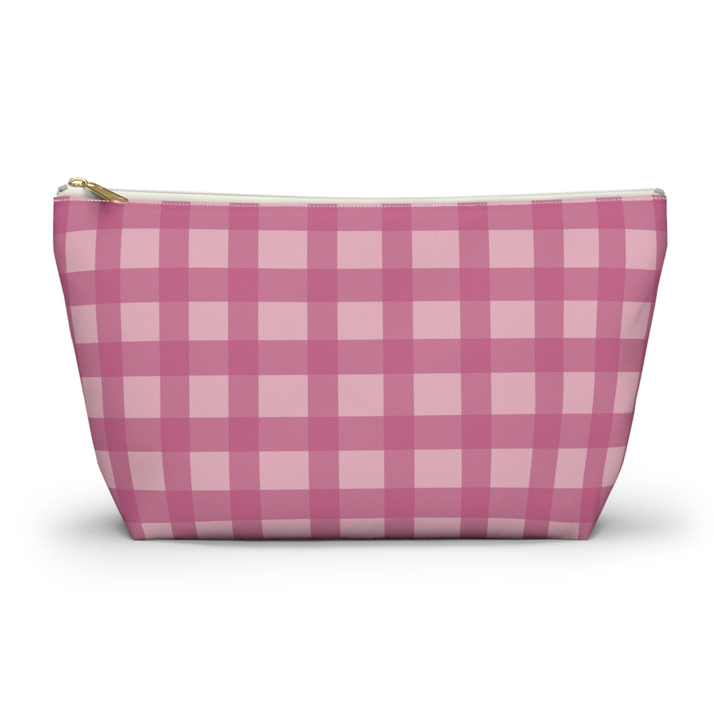 Pink gingham makeup bag with gold zipper pull on a white background