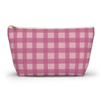 Pink gingham makeup bag with gold zipper pull on a white background