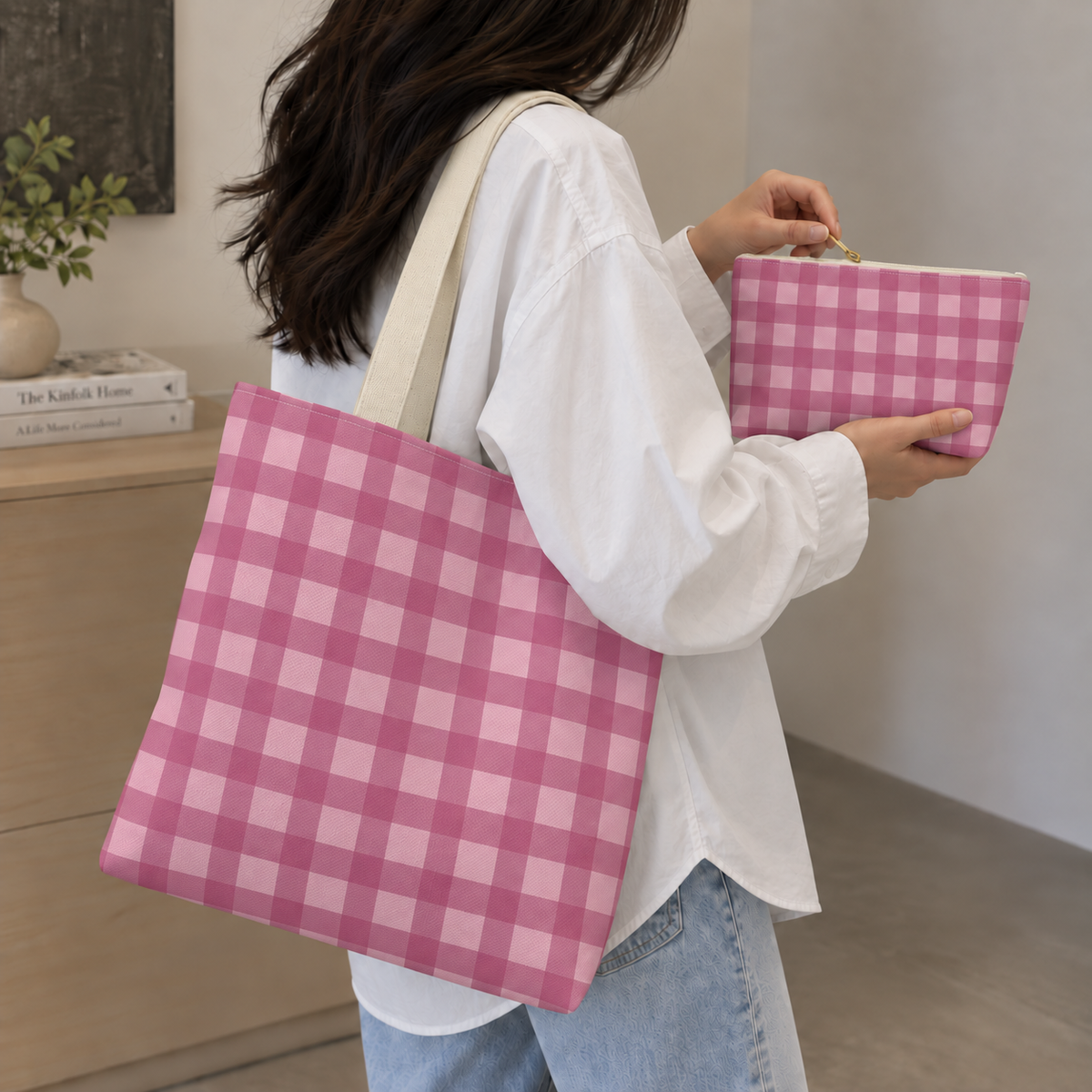 Woman carrying the gingham tote bag with the matching makeup bag in her hand
