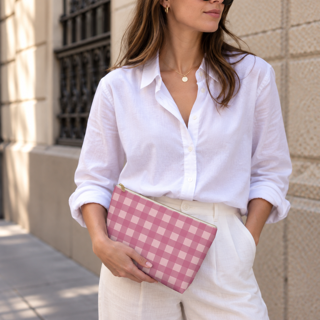 Model holding the pink gingham makeup bag like a clutch