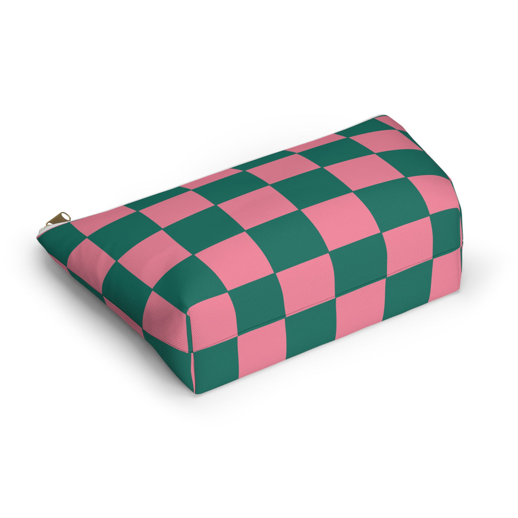 Pink green checkered makeup bag lying at an angle on a white background