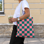 Woman with an iced drink wearing the pink green checkered tote bag on her shoulder