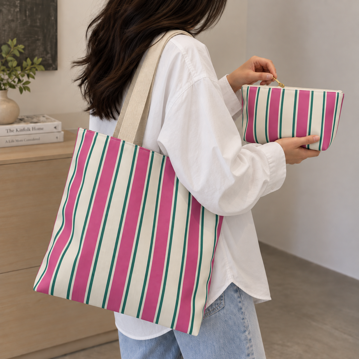 Model holding the Pink Green Cream Striped tote bag with the matching makeup bag