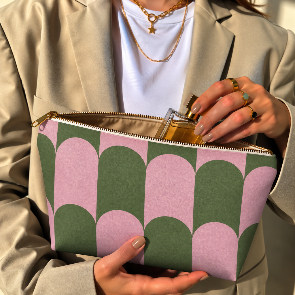 Model in a beige blazer taking a product out of the open pink green scallop makeup bag
