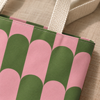 Close-up of the pink and green scallop print and beige handle on the tote bag