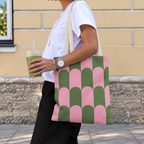 Side view of a model carrying the pink green scallop tote bag on the shoulder