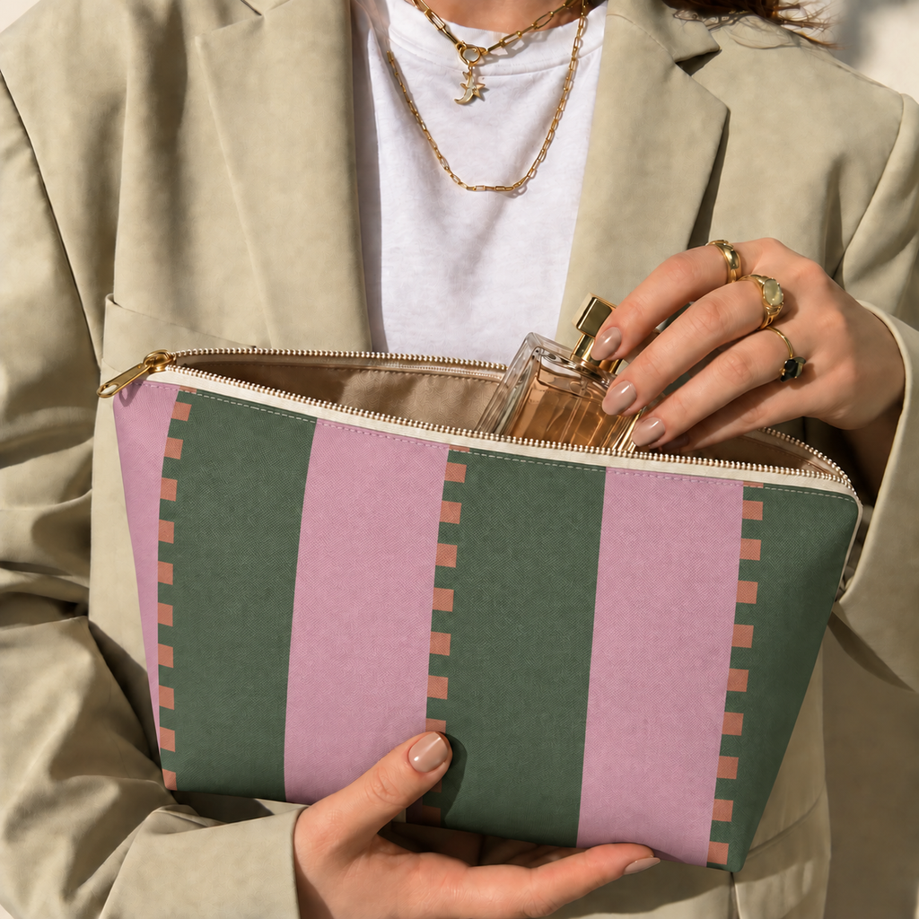 Open pink green striped makeup bag held in hands